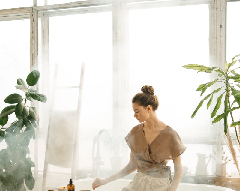 plants and a woman in the bathroom